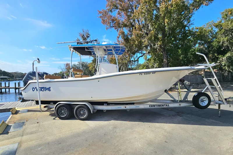 Slide: The Image of 2006 Key West 268 Center Console boat on trailer by the water. - 2
