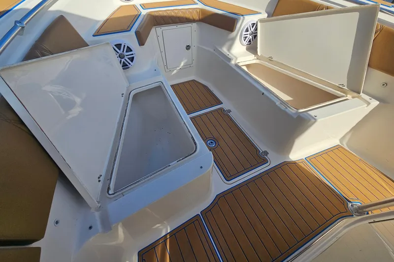 Slide: The Image of 2006 Key West 268 Center Console boat interior with open storage compartments and cushioned seating. - 20
