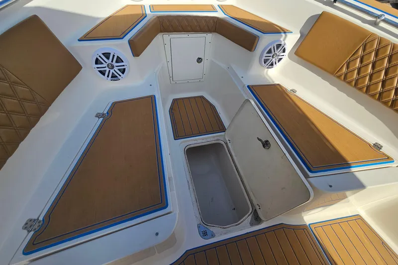 Slide: The Image of 2006 Key West 268 Center Console boat interior with storage compartments and cushioned seating. - 21