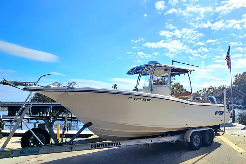 Slide: The Image of 2006 Key West 268 Center Console boat on trailer under clear blue sky. - 25