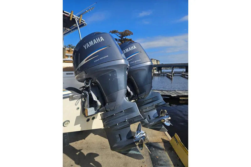 Slide: The Image of Twin Yamaha outboard motors on a 2006 Key West 268 Center Console boat by the dock. - 4