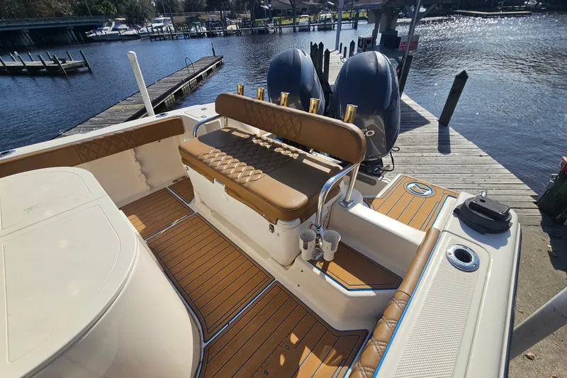 Slide: The Image of 2006 Key West 268 Center Console boat with dual engines docked by a scenic waterfront. - 5