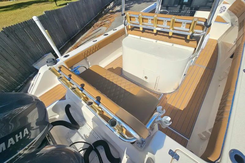 Slide: The Image of 2006 Key West 268 Center Console boat interior with Yamaha engines, featuring rod holders and seating. - 6
