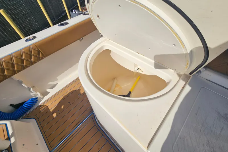 Slide: The Image of 2006 Key West 268 Center Console boat storage compartment with open lid. - 8