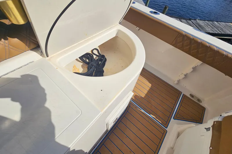 Slide: The Image of 2006 Key West 268 Center Console boat interior with storage compartment and rope. - 9
