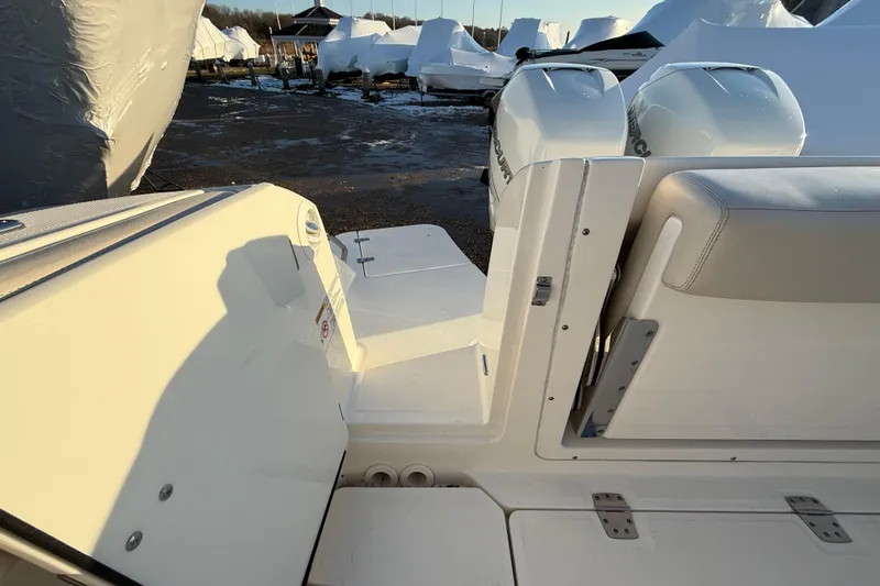 Slide: The Image of 2017 Boston Whaler 320 Vantage boat with dual Mercury engines, docked in a marina. - 14