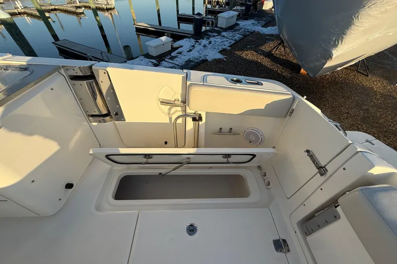 Slide: The Image of 2017 Boston Whaler 320 Vantage boat interior with open storage compartment. - 18