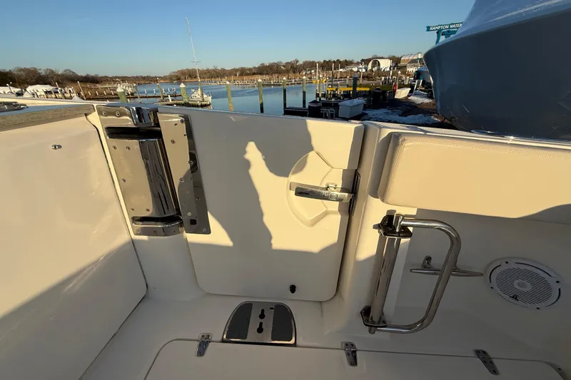 Slide: The Image of 2017 Boston Whaler 320 Vantage boat interior with dock view, featuring stainless steel fixtures. - 19