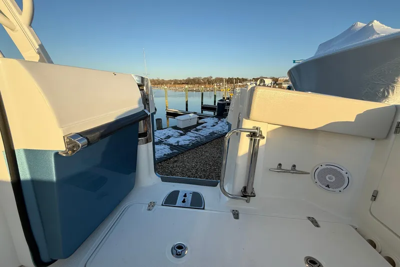 Slide: The Image of 2017 Boston Whaler 320 Vantage boat interior, docked at a marina under clear skies. - 20
