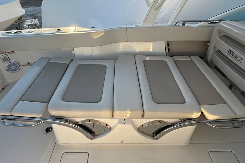 Slide: The Image of 2017 Boston Whaler 320 Vantage boat seating area with cushioned seats and stainless steel accents. - 23
