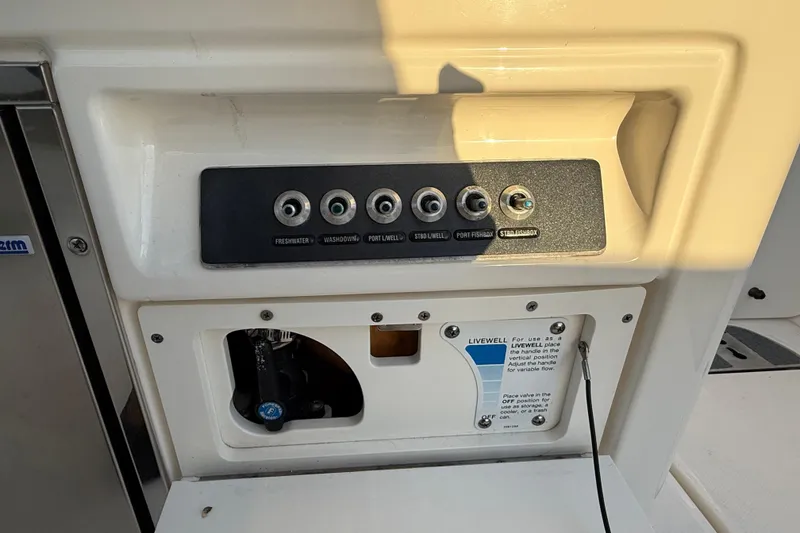 Slide: The Image of Control panel on a 2017 Boston Whaler 320 Vantage boat, featuring various switches. - 26