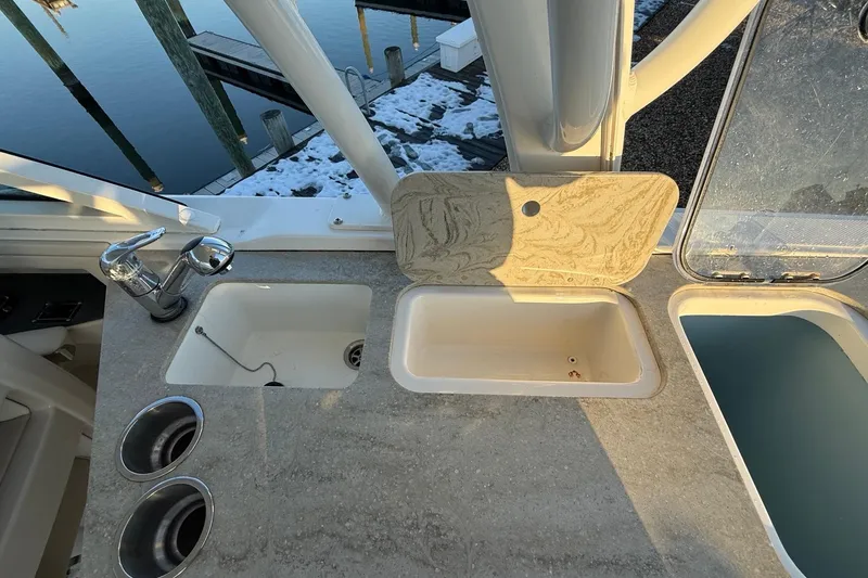 Slide: The Image of 2017 Boston Whaler 320 Vantage boat sink and countertop with marina view. - 31