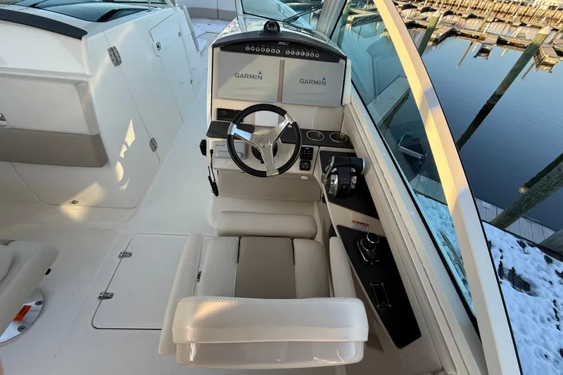 Slide: The Image of 2017 Boston Whaler 320 Vantage helm with Garmin navigation, docked by snowy pier. - 35