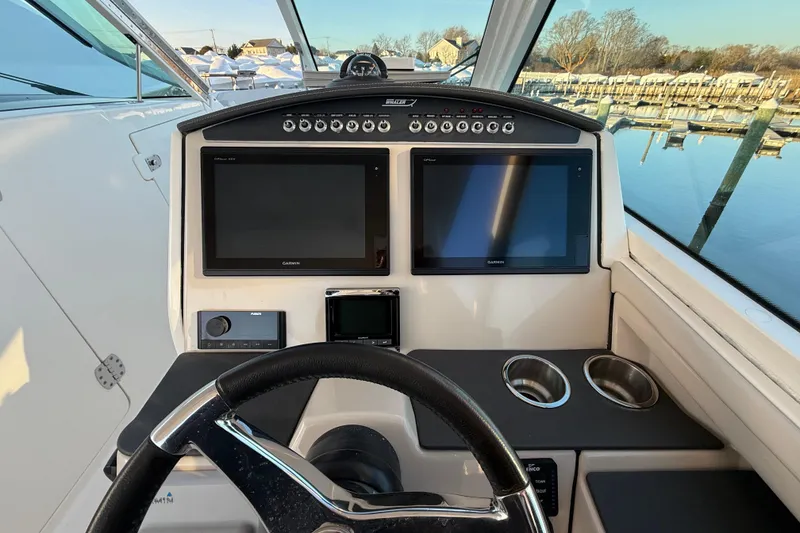 Slide: The Image of 2017 Boston Whaler 320 Vantage helm with dual Garmin displays and cup holders. - 39