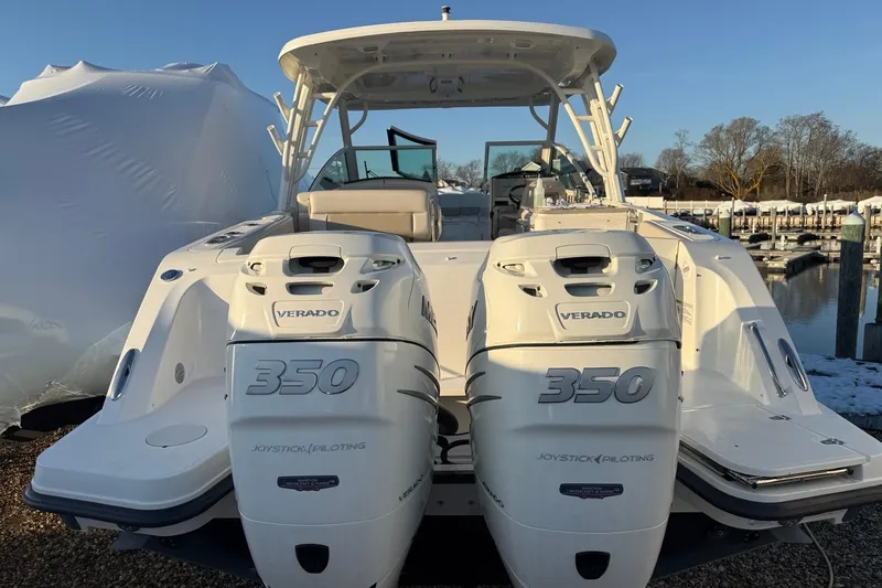 Slide: The Image of 2017 Boston Whaler 320 Vantage with twin Verado 350 engines at a marina. - 4