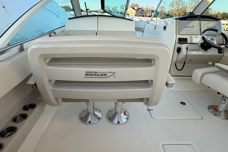 Slide: The Image of 2017 Boston Whaler 320 Vantage boat interior with helm and seating area. - 41