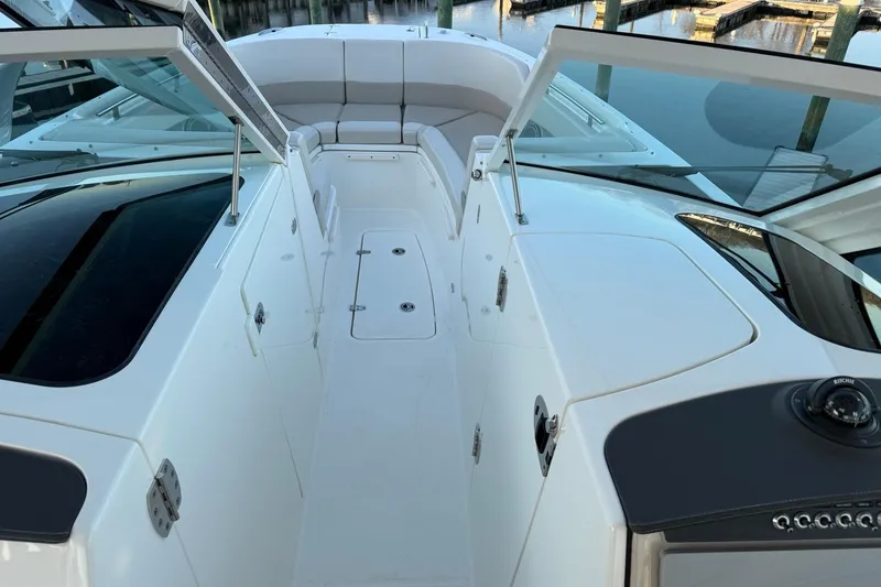 Slide: The Image of 2017 Boston Whaler 320 Vantage boat interior with seating and open deck view. - 49