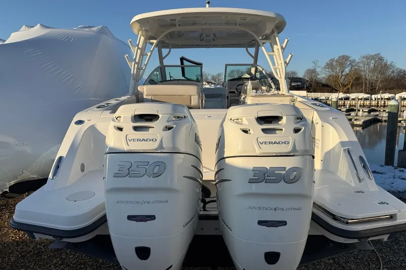 Slide: The Image of 2017 Boston Whaler 320 Vantage with dual Verado 350 engines at a marina. - 5
