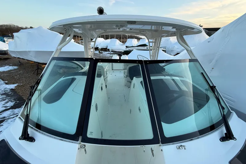 Slide: The Image of 2017 Boston Whaler 320 Vantage boat with sleek windshield and covered storage. - 54