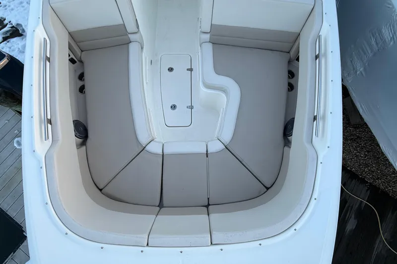 Slide: The Image of 2017 Boston Whaler 320 Vantage boat interior with cushioned seating and storage. - 58