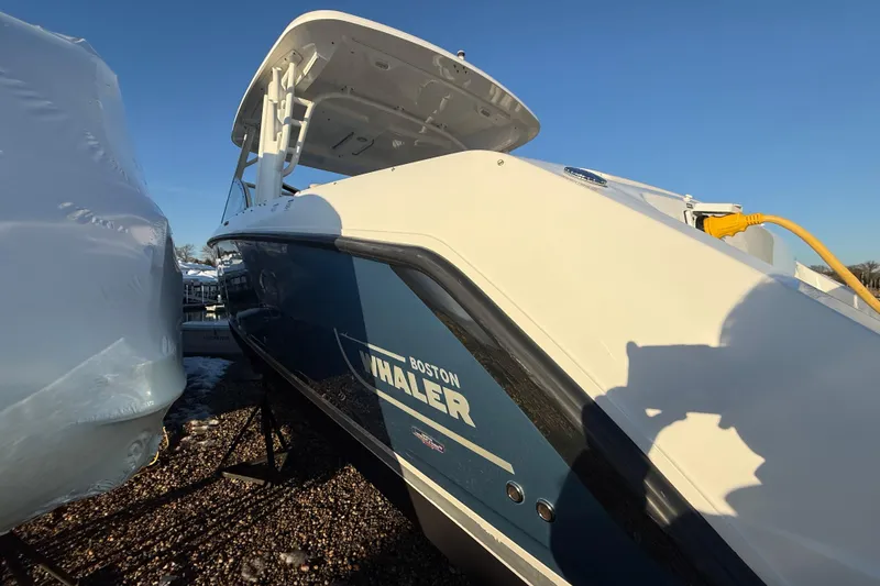 Slide: The Image of 2017 Boston Whaler 320 Vantage boat docked, showcasing sleek design and branding. - 6