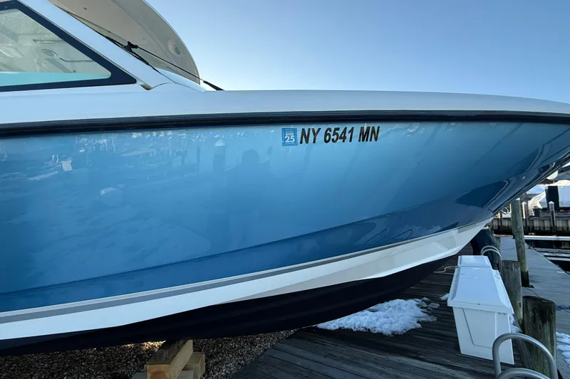 Slide: The Image of 2017 Boston Whaler 320 Vantage boat docked, displaying registration number NY 6541 MN. - 61