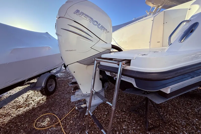 Slide: The Image of 2017 Boston Whaler 320 Vantage with Mercury Verado outboard engine, parked on gravel. - 8