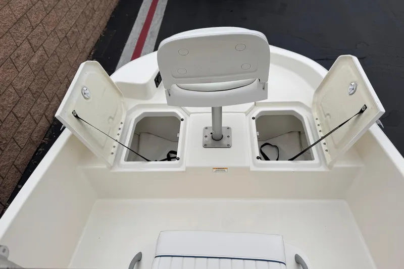 Slide: The Image of 2017 Bayliner Element F18 boat interior with open storage compartments and seating. - 10