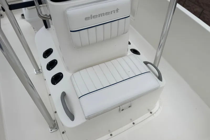 Slide: The Image of 2017 Bayliner Element F18 boat seating with white upholstery and stainless steel accents. - 13