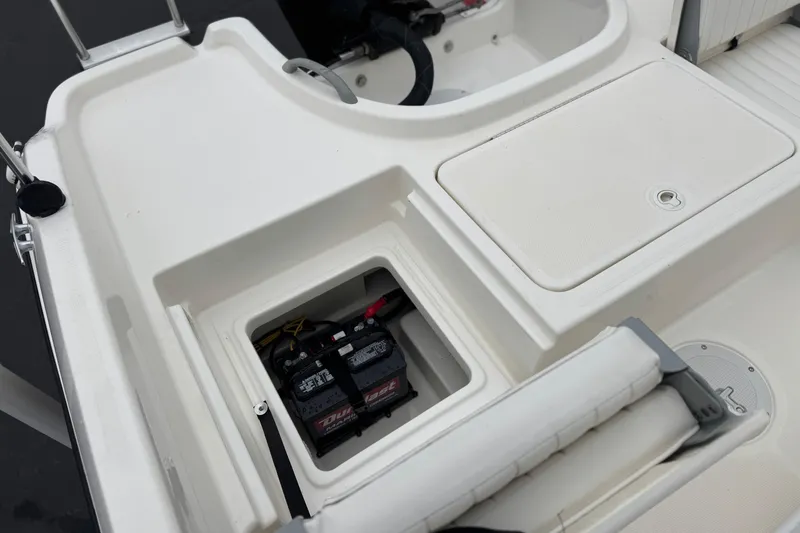 Slide: The Image of 2017 Bayliner Element F18 boat battery compartment with storage area. - 19