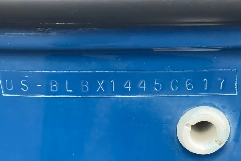 Slide: The Image of 2017 Bayliner Element F18 hull identification number on blue surface. - 25