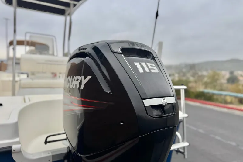 Slide: The Image of 2017 Bayliner Element F18 with Mercury 115 outboard motor, parked on a trailer. - 7