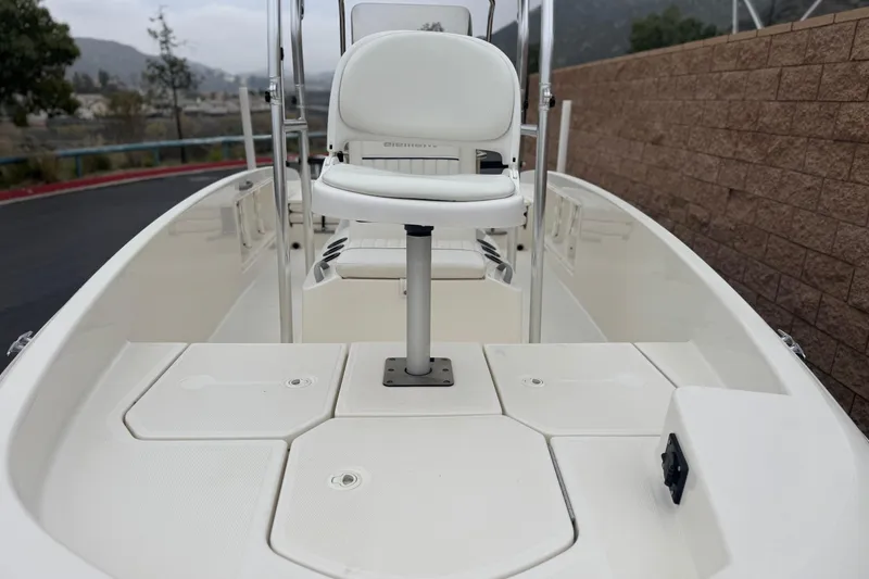 Slide: The Image of 2017 Bayliner Element F18 boat interior with seating and storage compartments. - 8