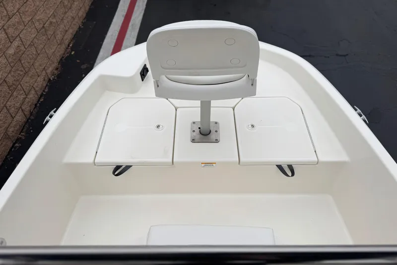 Slide: The Image of 2017 Bayliner Element F18 boat interior with white seating and storage compartments. - 9