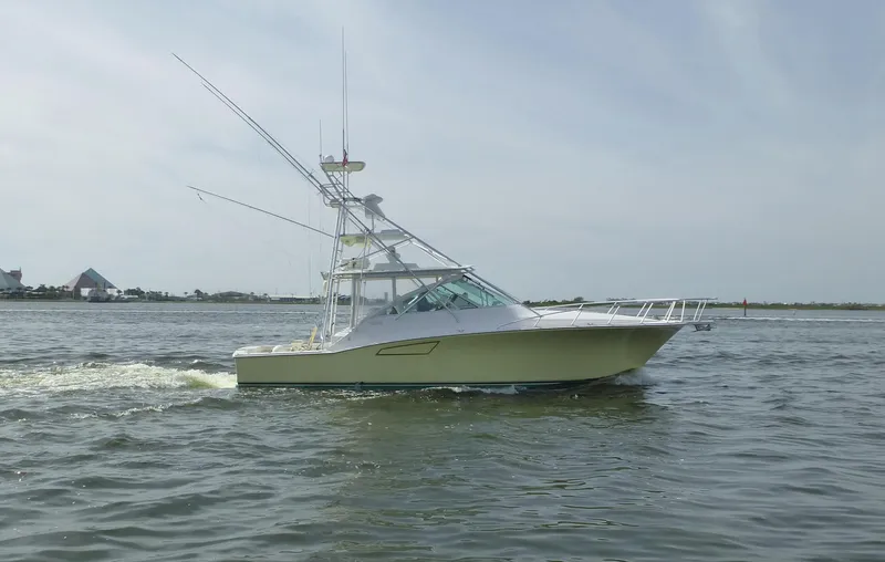 The Image of 2005 Cabo 40 Express yacht on calm water under a clear blue sky. - 0