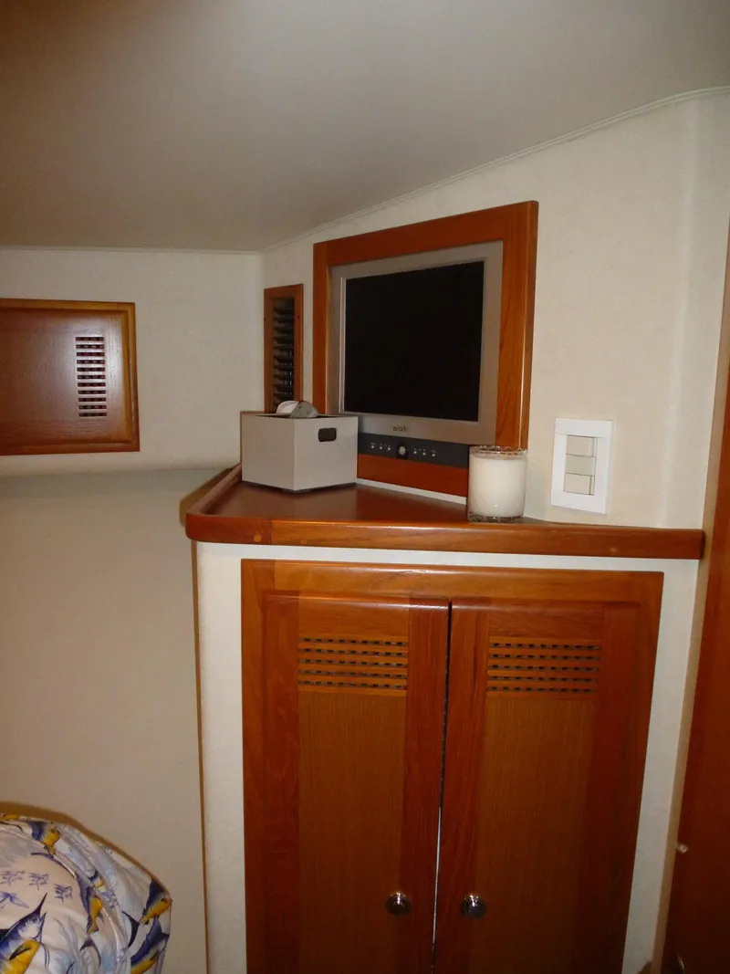 Slide: The Image of Luxurious 2005 Cabo 40 Express yacht interior with helm and seating, ocean view. - 11