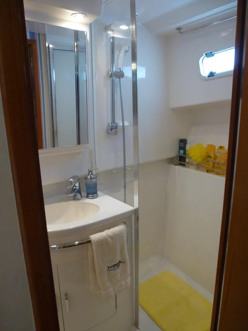 Slide: The Image of 2005 Cabo 40 Express yacht interior with white seating and ocean view. - 12