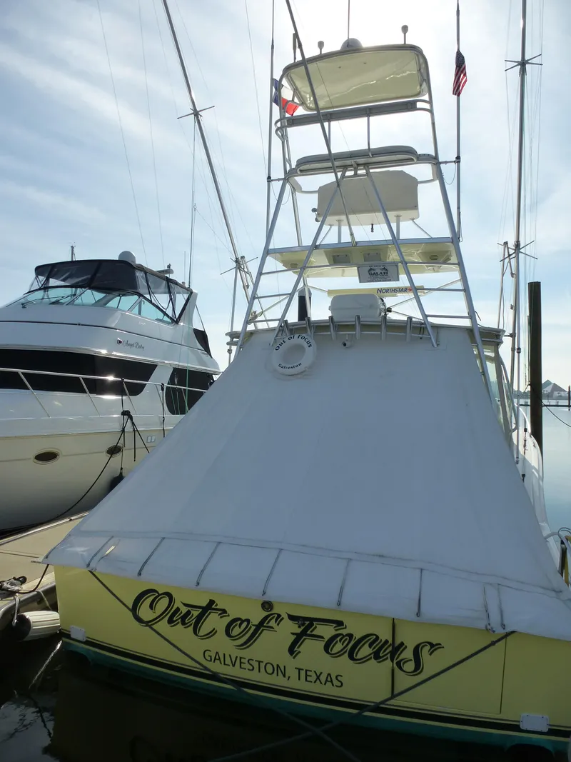 Slide: The Image of 2005 Cabo 40 Express yacht cockpit with white seating and ocean view. - 16