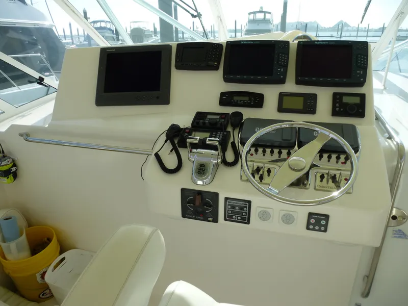 Slide: The Image of 2005 Cabo 40 Express boat deck with storage compartment under clear blue sky. - 23