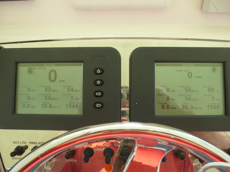 Slide: The Image of 2005 Cabo 40 Express boat deck with storage compartments under clear blue sky. - 25