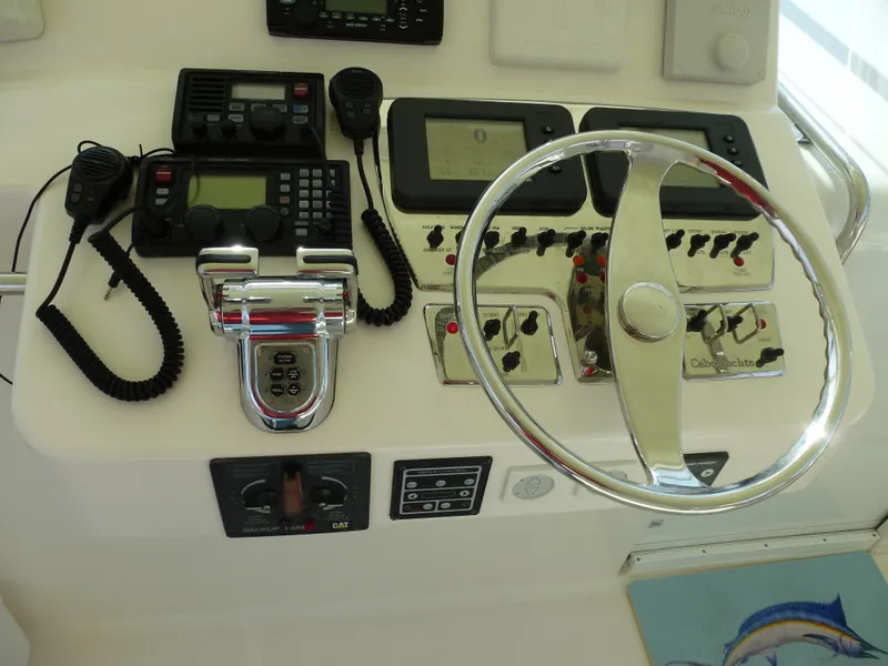 Slide: The Image of 2005 Cabo 40 Express boat deck with open storage compartments and ladder. - 26