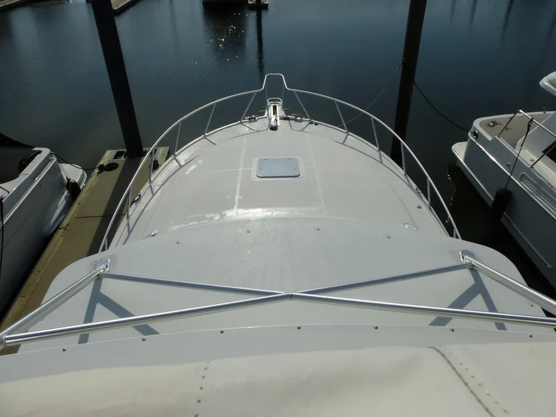Slide: The Image of Control panel of a 2005 Cabo 40 Express boat with steering wheel and navigation displays. - 33