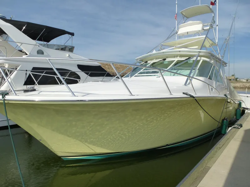 Slide: The Image of Helm of 2005 Cabo 40 Express yacht with navigation screens and controls, overlooking ocean. - 38