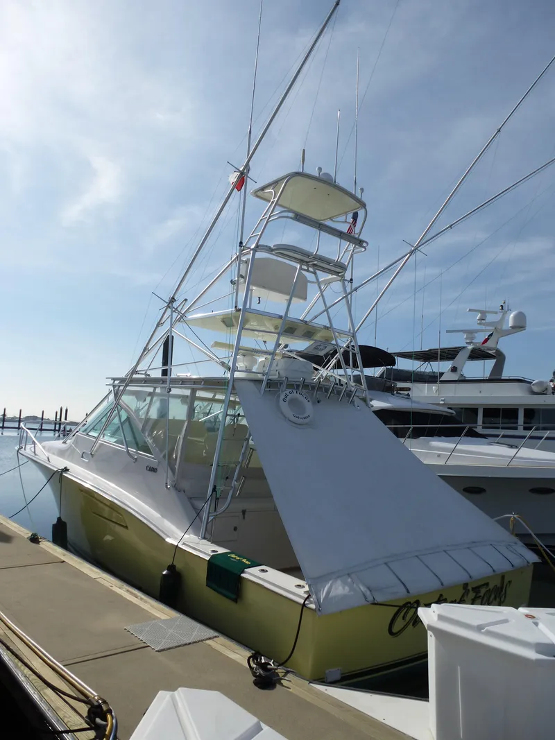 Slide: The Image of Control panel of 2005 Cabo 40 Express boat with navigation screens and steering wheel. - 39