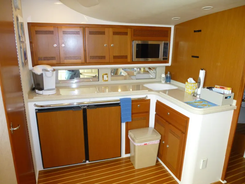 Slide: The Image of 2005 Cabo 40 Express yacht cruising on open water under clear blue skies. - 4