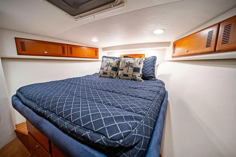 Slide: The Image of Luxurious cabin interior of 2005 Cabo 40 Express yacht with cozy bedding. - 43