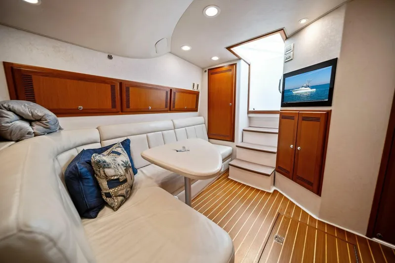 Slide: The Image of Luxurious interior of 2005 Cabo 40 Express yacht with plush seating and wooden accents. - 46