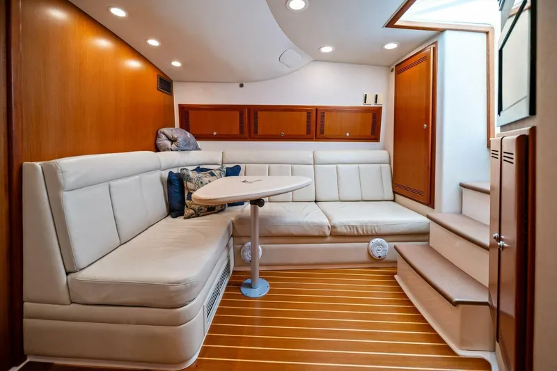 Slide: The Image of Luxurious interior of 2005 Cabo 40 Express yacht with plush seating and wooden accents. - 47