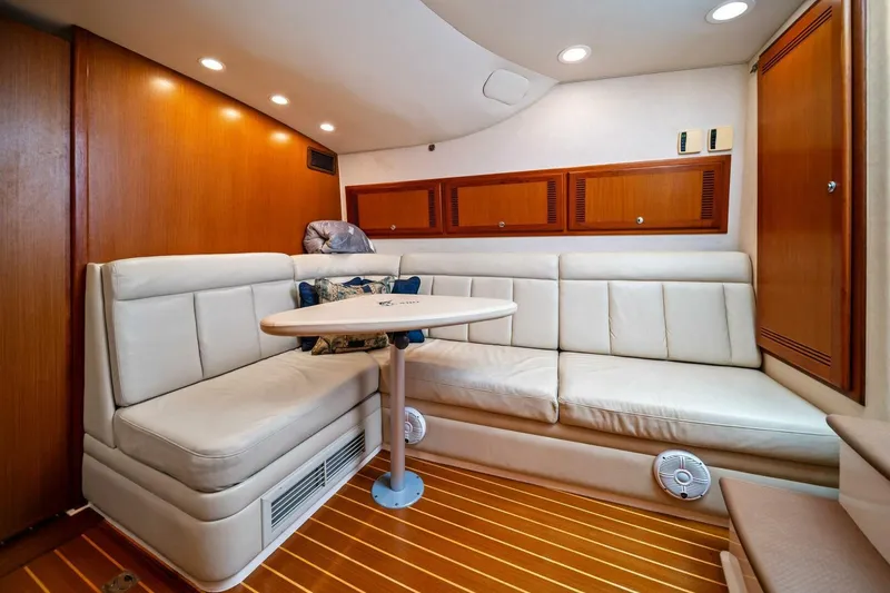 Slide: The Image of Luxurious interior of 2005 Cabo 40 Express yacht with plush seating and wooden accents. - 48