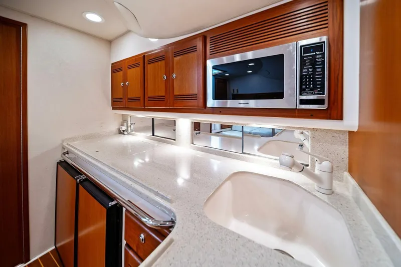 Slide: The Image of Luxurious 2005 Cabo 40 Express yacht kitchen with modern appliances and sleek cabinetry. - 52